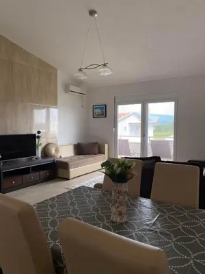 a living room with a table and a couch at MARSHAL Apartments in Donji Štoj