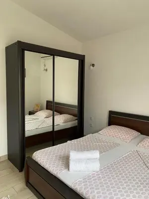 a bedroom with two beds and a mirror at MARSHAL Apartments in Donji Štoj