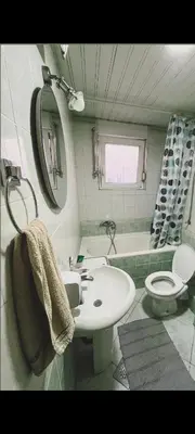 a bathroom with a sink and a toilet and a tub at Uživajte u mirnom i elegantnom smještaju in Podgorica