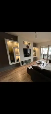 a living room with a couch and a table at Uživajte u mirnom i elegantnom smještaju in Podgorica