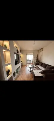 a living room with a couch and a table at Uživajte u mirnom i elegantnom smještaju in Podgorica