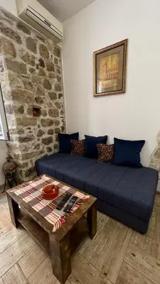 a living room with a couch and a table at Royal House in Kotor