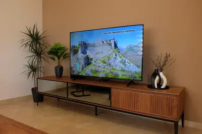 a flat screen tv sitting on top of a wooden entertainment center at Modern 1BR - Old Town and sea in Budva