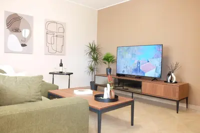 a living room with a flat screen tv on a table at Modern 1BR - Old Town and sea in Budva