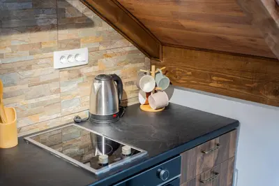 a kitchen counter with a sink and a coffee maker at Agape Apartments in Kotor