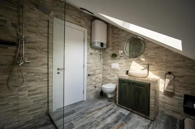 a bathroom with a toilet and a glass shower at Agape Apartments in Kotor