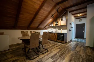 a kitchen with a table and chairs in a room at Agape Apartments in Kotor