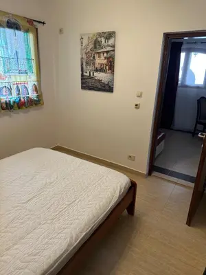 a bedroom with a bed and a picture on the wall at Tri bora in Bar