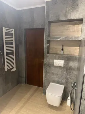 a bathroom with a toilet and a brown door at Tri bora in Bar