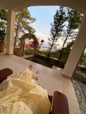 a man in a wedding dress laying on a patio at Tri bora in Bar