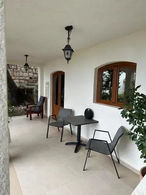 a patio with a table and chairs in a room at Tri bora in Bar