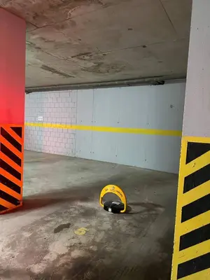 an empty parking garage with a yellow object on the floor at Apartment in the Lusitanos in Budva