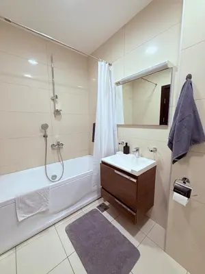 a bathroom with a tub and a sink and a shower at Apartment in the Lusitanos in Budva