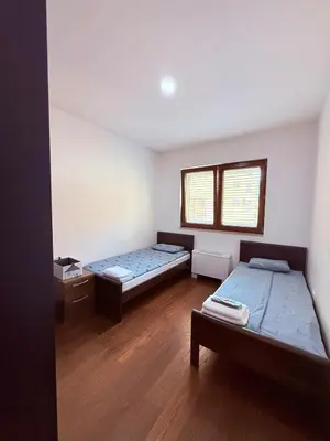 a room with two beds and a window at Apartment in the Lusitanos in Budva
