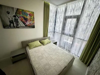 a bedroom with a bed and a large window at Apartman Velsma in Budva