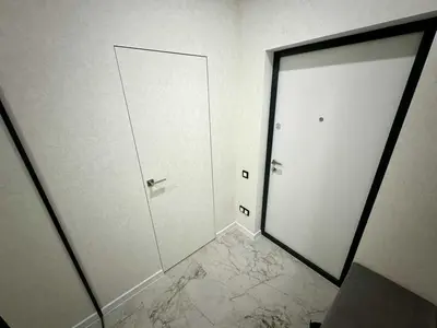 a white room with a door and a mirror at Apartman Velsma in Budva