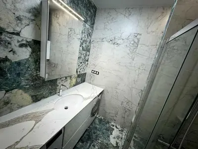 a bathroom with a sink and a shower at Apartman Velsma in Budva
