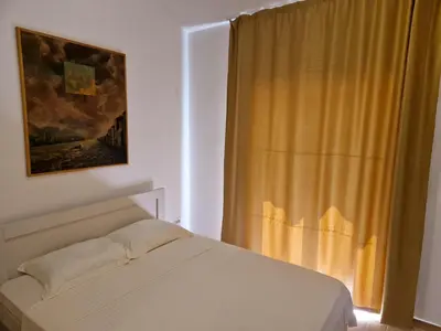 a bedroom with a bed and a window at Villa Bougainvilla in Becici