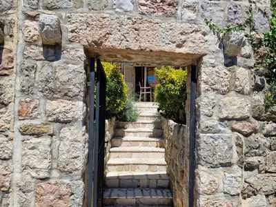 an entrance to a stone building with a door and stairs at Villa Bougainvilla in Becici