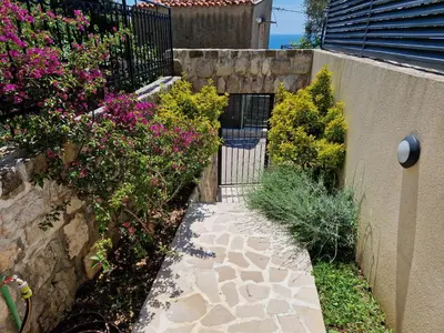 a garden with pink flowers and a fence at Villa Bougainvilla in Becici