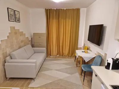 a living room with a couch and a table at Villa Bougainvilla in Becici