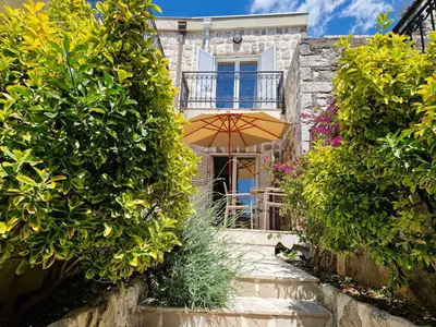 a house with an umbrella and a patio at Villa Bougainvilla in Becici