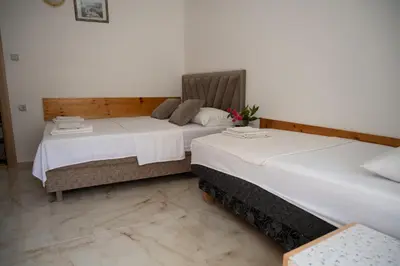 two beds sitting next to each other in a room at apartmani DENI in Donji Štoj