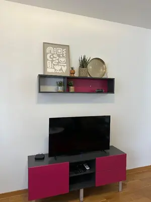 a flat screen tv sitting on top of a entertainment center at District Loft in Podgorica