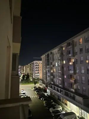 a view of a parking lot in a city at night at District Loft in Podgorica
