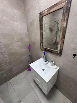a bathroom with a white sink and a mirror at Apartment Oaza in Budva