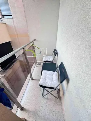 a chair sitting on top of a balcony at Apartment Oaza in Budva