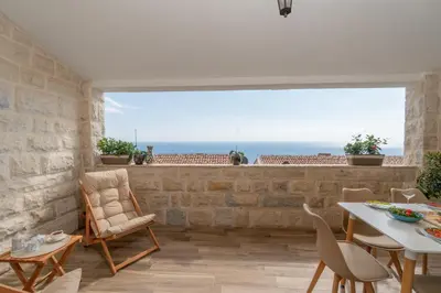 a dining room with a view of the ocean at Emilys View Rezevici in Katun