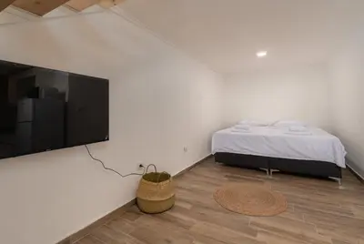a bedroom with a bed and a flat screen tv at Emilys View Rezevici in Katun