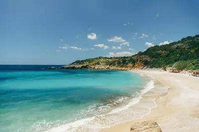 a beach with turquoise water and a mountain at Emilys View Rezevici in Katun