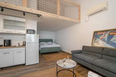 a living room with a couch and a kitchen at Emilys View Rezevici in Katun