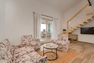 a living room with two couches and a table at Emilys View Rezevici in Katun