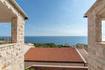 a view of the ocean from the balcony of a house at Emilys View Rezevici in Katun