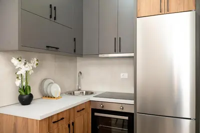 a kitchen with a refrigerator and a sink at LA PERLA apartments 16 in Ulcinj
