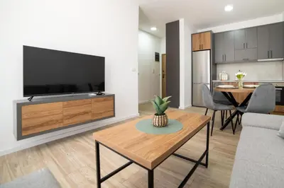 a living room with a large television and a table at LA PERLA apartments 14 in Ulcinj