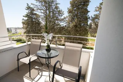 a balcony with a glass table and two chairs at LA PERLA apartments 14 in Ulcinj