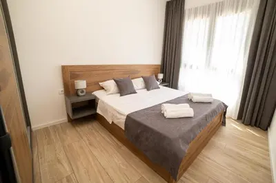 a bedroom with a bed with two towels on it at LA PERLA apartments 14 in Ulcinj