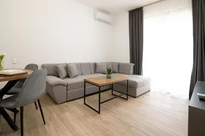 a living room with a couch and a table at LA PERLA apartments 14 in Ulcinj