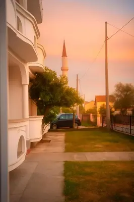 a car parked next to a building with a mosque at Apartments Hija in Donji Štoj