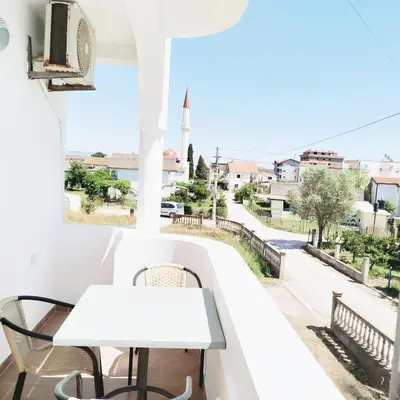a table on a balcony with a view of a street at Apartments Hija in Donji Štoj