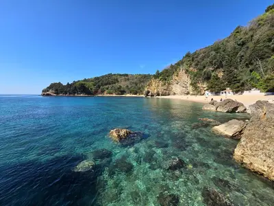 a view of a beach with rocks and the water at Доброморе Будва in Budva