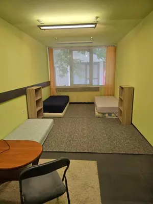 a room with two beds and a table and chairs at Доброморе Будва in Budva