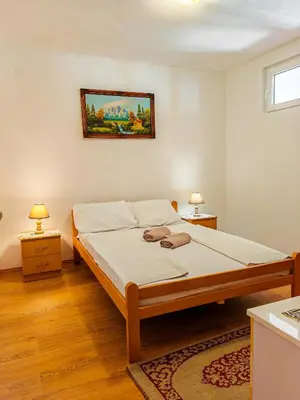 a bedroom with a bed and two night stands at Zora Apartments in Bar