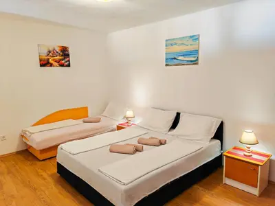 two beds in a small room with two lamps at Zora Apartments in Bar