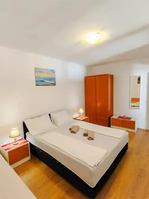 a bedroom with a bed with two shoes on it at Zora Apartments in Bar