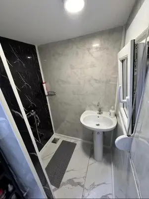 a small bathroom with a sink and a shower at Kucica obala in Železnička Stanica Zeta